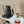 Black electric kettle with wooden detail on the handle and narrow spout for barista and brew accessories all about coffee.