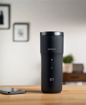 Electric Coffee Travel Mug black V2 - 355ml on table with digital temperature display in modern indoor setting.