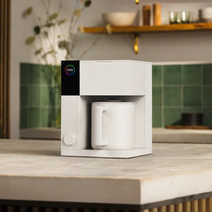 Modern white precision brewer with integrated mug for manual brewing, part of Fellow, Latest news, all about coffee.