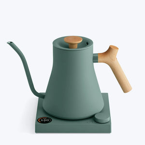 Green kettle with wooden handle and long narrow spout for precise brewing, part of Fellow, EspressoGear, all about coffee