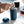 Hand inserting filter into matte blue reusable coffee cup, part of Take away and EspressoGear, all about coffee.