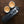 Portable espresso machine with two cups of espresso on a wooden surface, from portable coffee makers and barista equipment